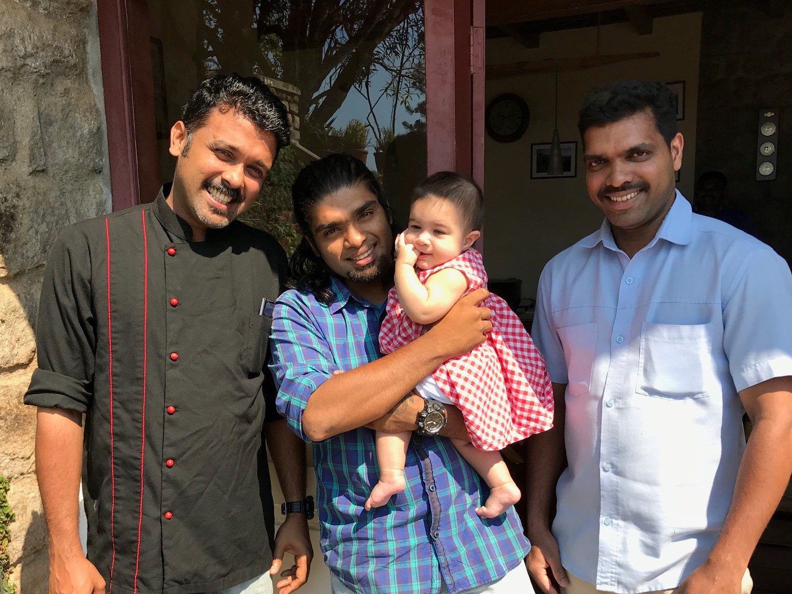 My daughter with the wonderful hotel staff at Windermere Estate in Munnar, India