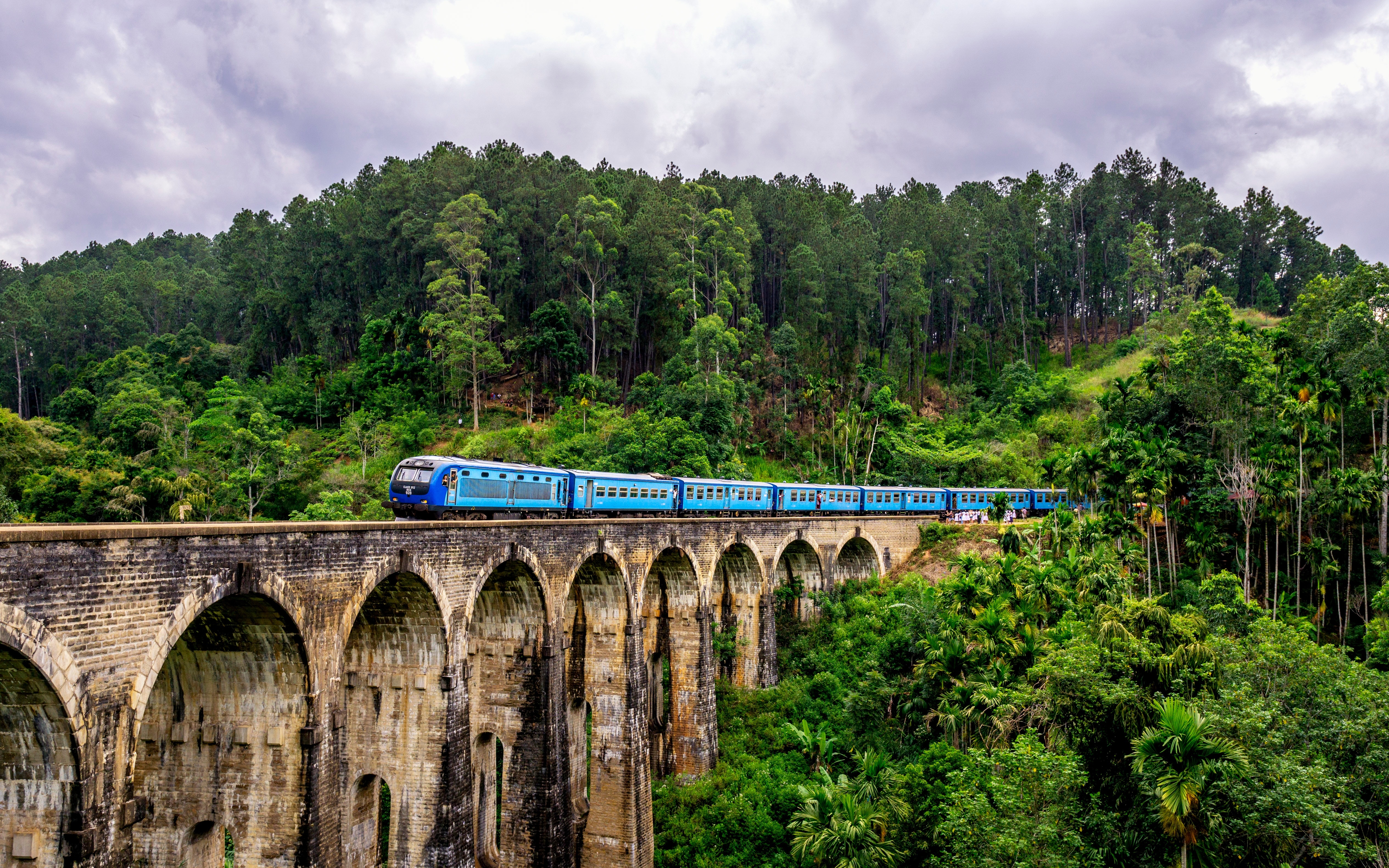 Traveling by train over Nine Arch Bridge in Sri Lanka